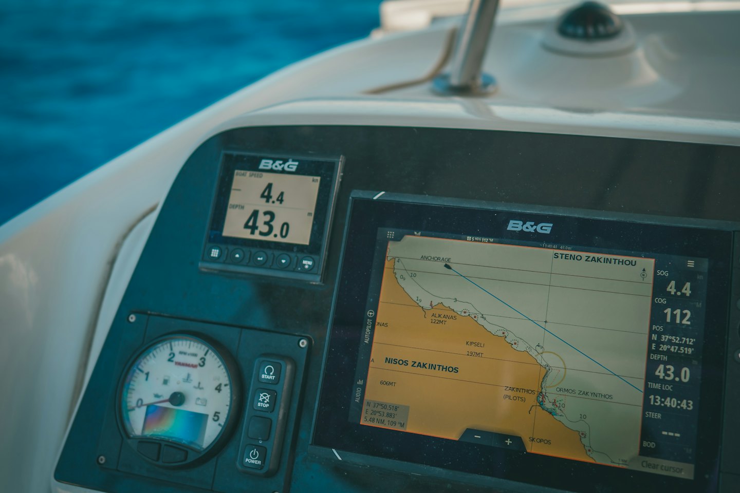 Boat dashboard displays navigation charts and digital gauges.